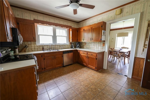 5243 Flanders Rd, Toledo, OH 43623 - kitchen with appliances with stainless steel finishes, a sink, plenty of natural light, brown cabinets, and crown molding