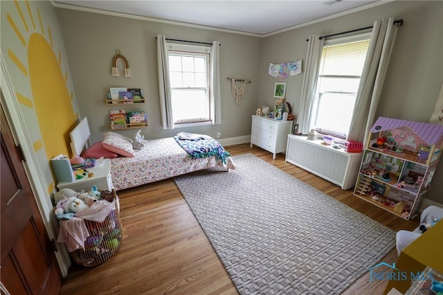 5243 Flanders Rd, Toledo, OH 43623 - bedroom with wood finished floors, ornamental molding, radiator, and baseboards