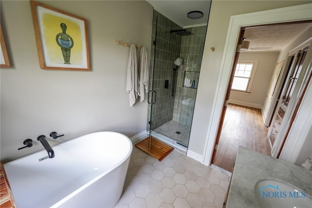 5243 Flanders Rd, Toledo, OH 43623 - full bathroom featuring a shower stall, a soaking tub, tile patterned floors, vanity, and baseboards
