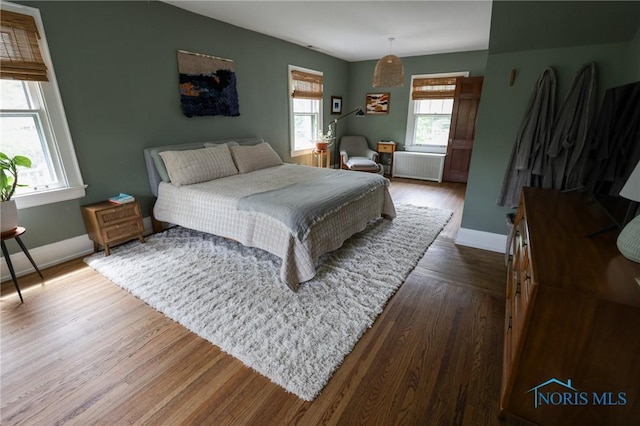 5243 Flanders Rd, Toledo, OH 43623 - bedroom featuring radiator heating unit, wood finished floors, and baseboards