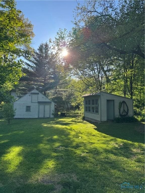 5243 Flanders Rd, Toledo, OH 43623 - view of green lawn featuring an outbuilding