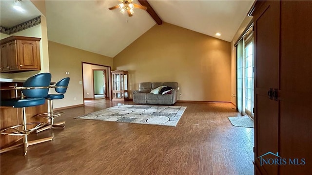 12327 Buckeye Dr, Paulding, OH 45879 - living room with ceiling fan, beamed ceiling, wood finished floors, high vaulted ceiling, and baseboard heating