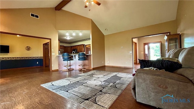 12327 Buckeye Dr, Paulding, OH 45879 - living room with high vaulted ceiling, ceiling fan, dark wood-type flooring, and beam ceiling