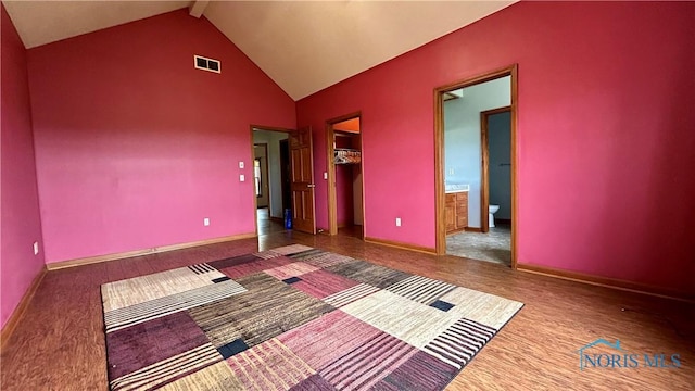 12327 Buckeye Dr, Paulding, OH 45879 - unfurnished bedroom featuring a spacious closet, beamed ceiling, a closet, high vaulted ceiling, and ensuite bath