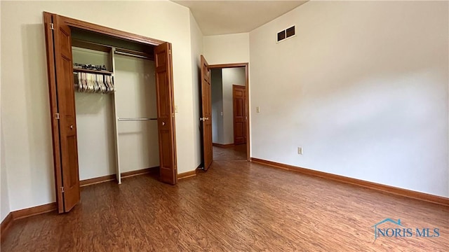 12327 Buckeye Dr, Paulding, OH 45879 - unfurnished bedroom featuring dark wood-style flooring and a closet