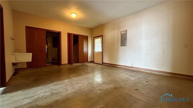 12327 Buckeye Dr, Paulding, OH 45879 - empty room featuring electric panel and concrete flooring