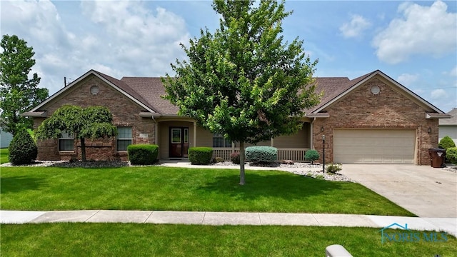 12327 Buckeye Dr, Paulding, OH 45879 - view of front of property with a garage, driveway, brick siding, a front lawn, and roof with shingles