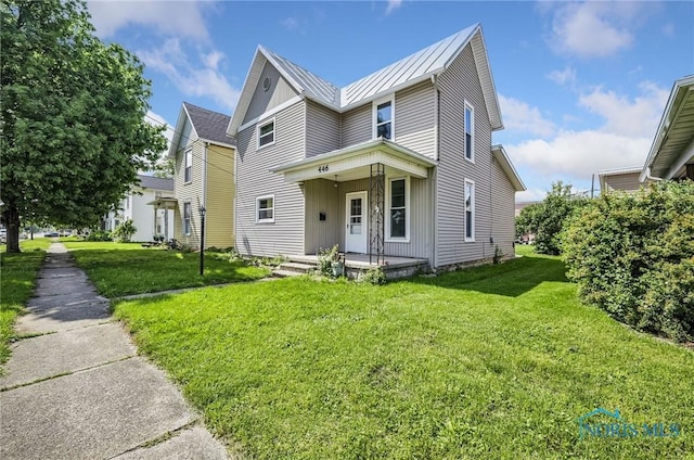 446 Center St, Findlay, OH 45840 - view of front of house with a standing seam roof, a front lawn, metal roof, and covered porch