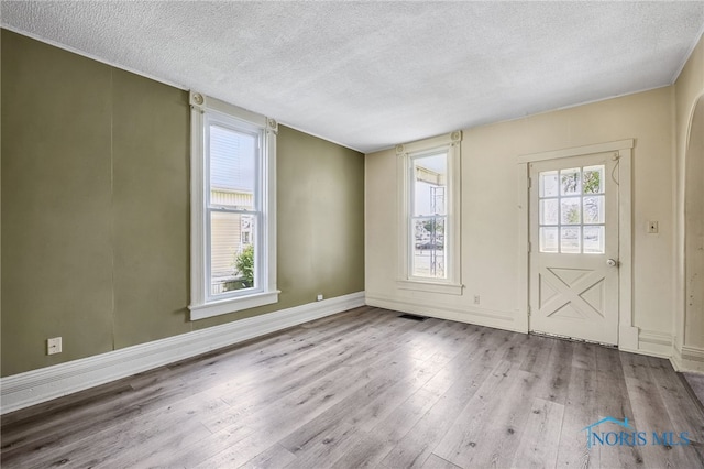 446 Center St, Findlay, OH 45840 - foyer with a textured ceiling, wood finished floors, and baseboards