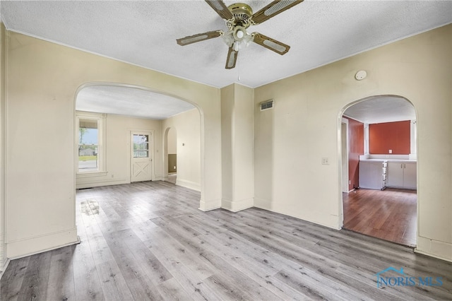 446 Center St, Findlay, OH 45840 - unfurnished room with arched walkways, a ceiling fan, wood finished floors, a textured ceiling, and a smoke detector