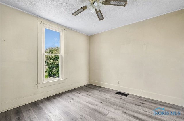 446 Center St, Findlay, OH 45840 - spare room with a textured ceiling, wood finished floors, a ceiling fan, and baseboards