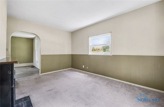 446 Center St, Findlay, OH 45840 - carpeted empty room with arched walkways and baseboards