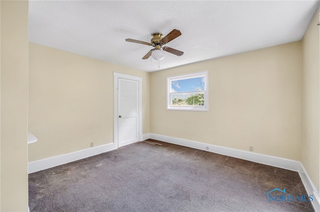 446 Center St, Findlay, OH 45840 - spare room with a ceiling fan, dark carpet, baseboards, and a textured ceiling