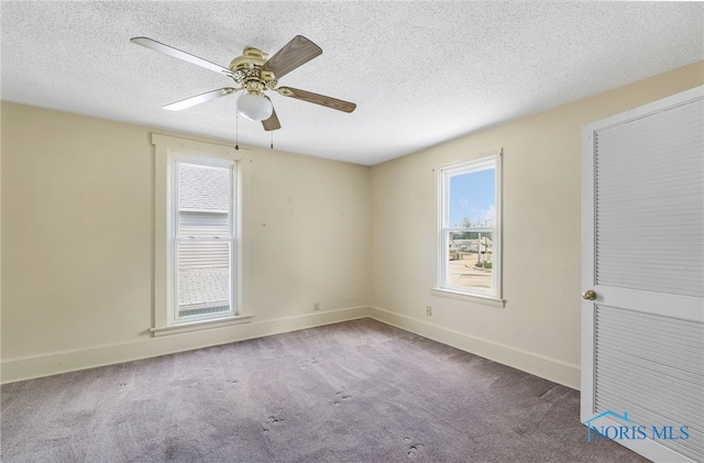 446 Center St, Findlay, OH 45840 - carpeted spare room with healthy amount of natural light, a textured ceiling, baseboards, and ceiling fan