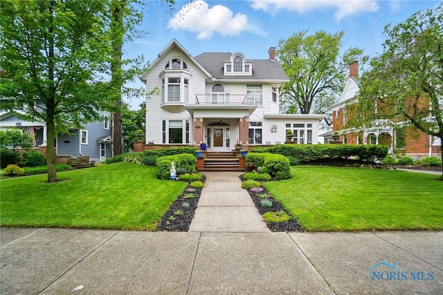 1100 S Main St, Findlay, OH 45840 - victorian home with a balcony and a front lawn