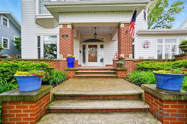 1100 S Main St, Findlay, OH 45840 - view of exterior entry with covered porch and brick siding