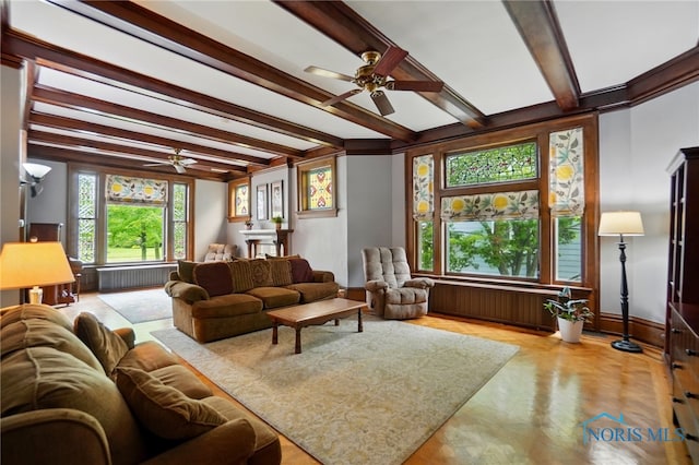 1100 S Main St, Findlay, OH 45840 - living room featuring a ceiling fan, radiator heating unit, beam ceiling, and baseboards