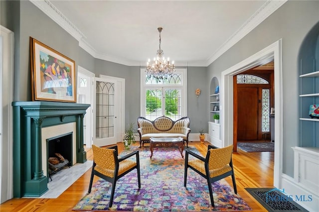 1100 S Main St, Findlay, OH 45840 - sitting room with wood finished floors, plenty of natural light, a chandelier, crown molding, and a fireplace with flush hearth