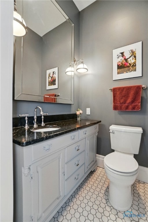 1100 S Main St, Findlay, OH 45840 - bathroom featuring baseboards, vanity, and toilet