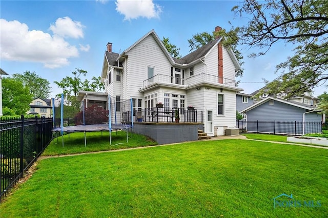 1100 S Main St, Findlay, OH 45840 - back of property featuring a chimney, a trampoline, a balcony, and central AC unit