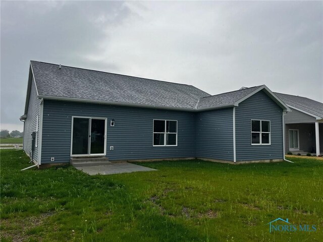 4015 E Plaza Blvd, Northwood, OH 43619 - rear view of property with entry steps, a lawn, a shingled roof, and a patio