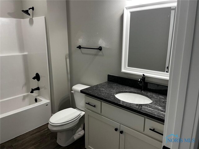 4015 E Plaza Blvd, Northwood, OH 43619 - full bathroom featuring wood finished floors, vanity, toilet, and tub / shower combination