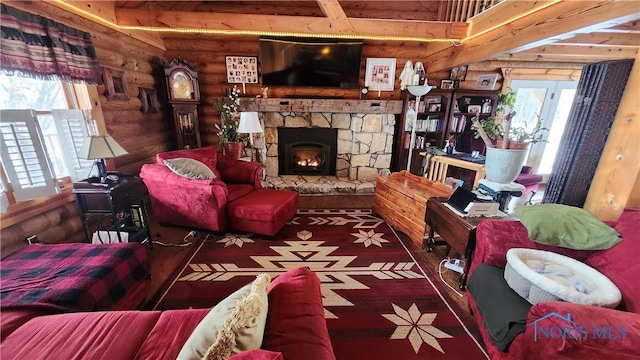 17884 Euler Rd, Bowling Green, OH 43402 - living room with log walls, beamed ceiling, a stone fireplace, and wood finished floors