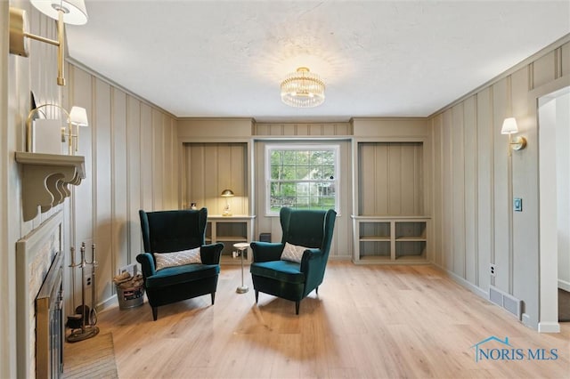 2222 Talmadge Rd, Ottawa Hills, OH 43606 - living area with wood finished floors, a chandelier, a decorative wall, ornamental molding, and baseboards