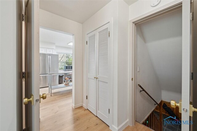2222 Talmadge Rd, Ottawa Hills, OH 43606 - hall featuring an upstairs landing, light wood finished floors, and baseboards