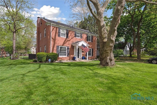 2222 Talmadge Rd, Ottawa Hills, OH 43606 - colonial inspired home featuring brick siding, a chimney, and central air condition unit