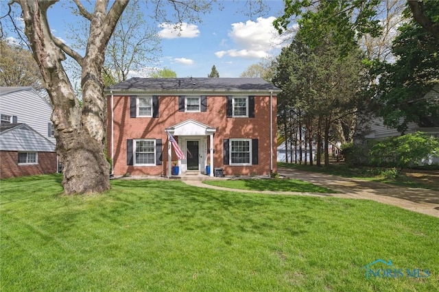 2222 Talmadge Rd, Ottawa Hills, OH 43606 - colonial home featuring a front yard and brick siding