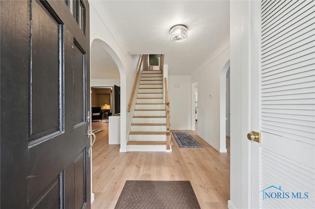 2222 Talmadge Rd, Ottawa Hills, OH 43606 - entryway with arched walkways, light wood-type flooring, stairway, and baseboards
