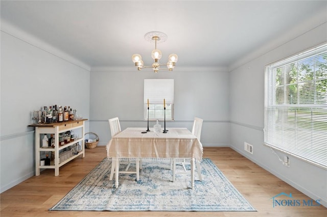 2222 Talmadge Rd, Ottawa Hills, OH 43606 - dining space featuring a chandelier, light wood finished floors, baseboards, and crown molding