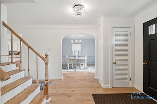 2222 Talmadge Rd, Ottawa Hills, OH 43606 - foyer with arched walkways, stairs, light wood-type flooring, and baseboards
