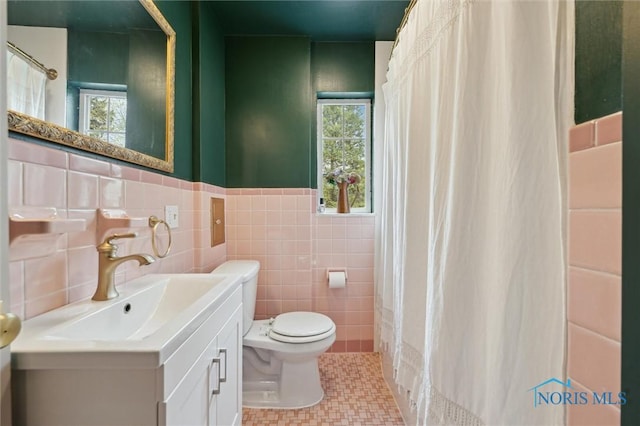 2222 Talmadge Rd, Ottawa Hills, OH 43606 - full bath featuring toilet, tile walls, vanity, a wainscoted wall, and a shower with shower curtain
