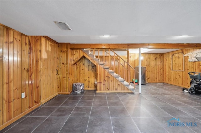 2222 Talmadge Rd, Ottawa Hills, OH 43606 - finished below grade area featuring water heater, stairs, wooden walls, baseboards, and tile patterned floors