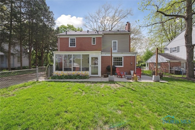 2222 Talmadge Rd, Ottawa Hills, OH 43606 - rear view of house featuring a patio area, a chimney, brick siding, and a sunroom