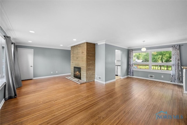 4550 W Sylvania Ave, Toledo, OH 43623 - unfurnished living room with crown molding, baseboards, a large fireplace, wood finished floors, and recessed lighting