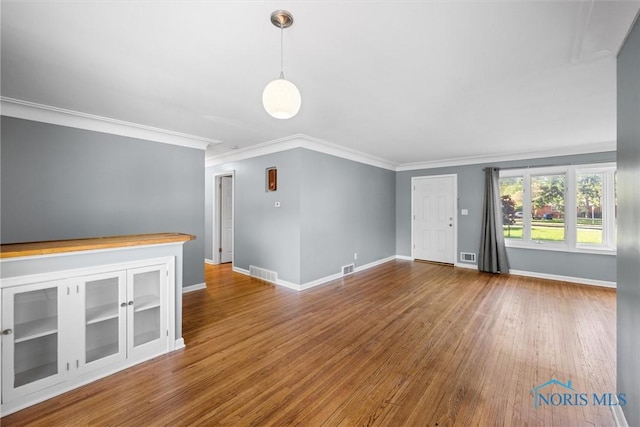 4550 W Sylvania Ave, Toledo, OH 43623 - unfurnished living room with crown molding, wood finished floors, and baseboards