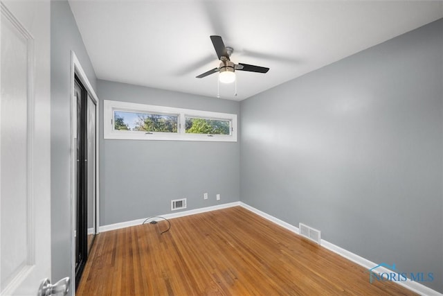 4550 W Sylvania Ave, Toledo, OH 43623 - unfurnished bedroom featuring wood finished floors, a closet, baseboards, and a ceiling fan