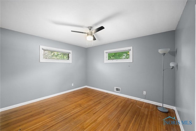 4550 W Sylvania Ave, Toledo, OH 43623 - empty room featuring healthy amount of natural light, baseboards, wood finished floors, and a ceiling fan