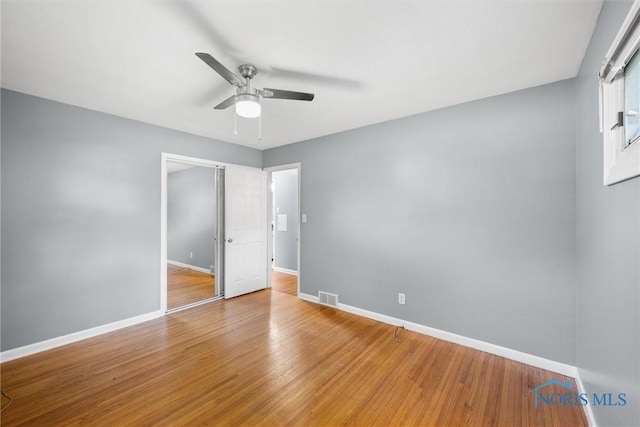 4550 W Sylvania Ave, Toledo, OH 43623 - unfurnished bedroom featuring baseboards, light wood-style floors, and a ceiling fan