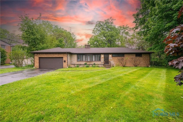 4550 W Sylvania Ave, Toledo, OH 43623 - single story home featuring driveway, an attached garage, brick siding, a chimney, and a yard