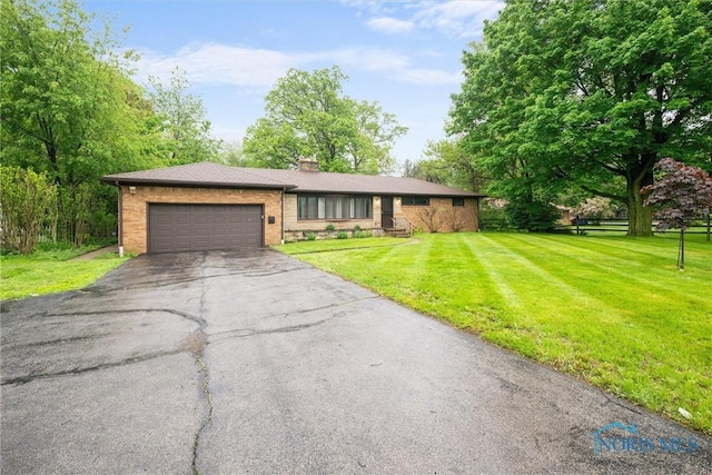 4550 W Sylvania Ave, Toledo, OH 43623 - ranch-style home with driveway, an attached garage, a chimney, a front lawn, and brick siding