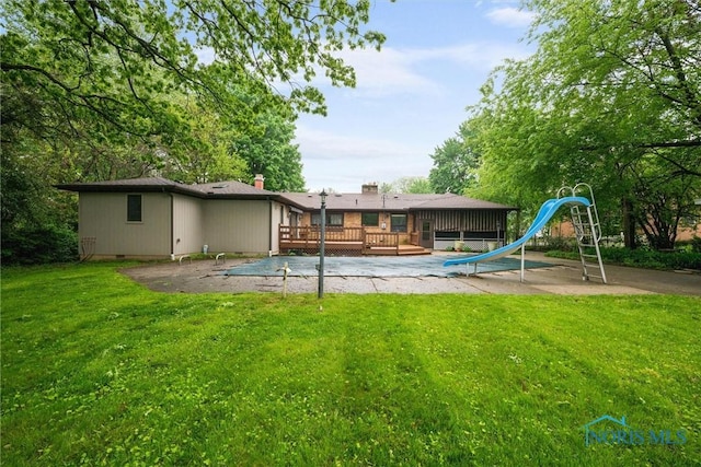 4550 W Sylvania Ave, Toledo, OH 43623 - rear view of property with a deck and a lawn