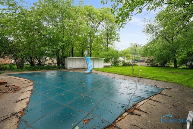 4550 W Sylvania Ave, Toledo, OH 43623 - view of pool featuring a covered pool, a lawn, and a storage shed
