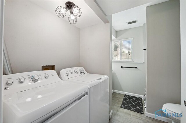 513 Bay River Ct, Maumee, OH 43537 - washroom featuring washer and dryer, baseboards, and light wood finished floors