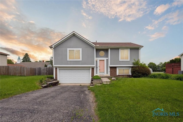 513 Bay River Ct, Maumee, OH 43537 - bi-level home with asphalt driveway and an attached garage