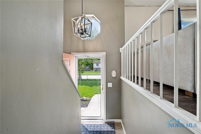 513 Bay River Ct, Maumee, OH 43537 - doorway with a chandelier, baseboards, and a high ceiling