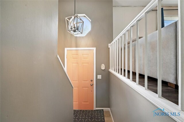 513 Bay River Ct, Maumee, OH 43537 - doorway with a chandelier, baseboards, and healthy amount of natural light